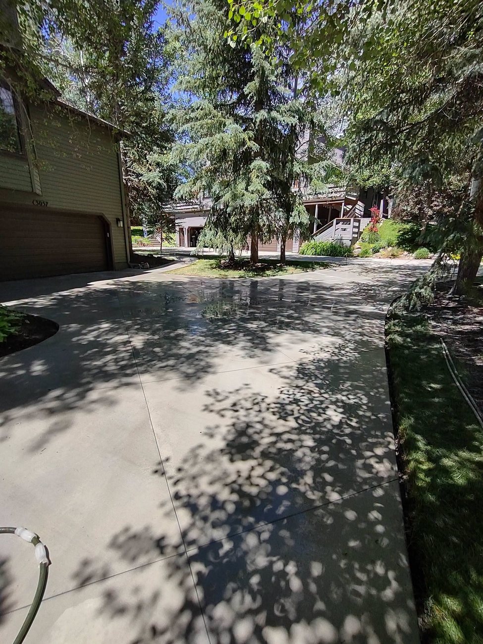 A finished concrete patio and walkway in a Davis County backyard