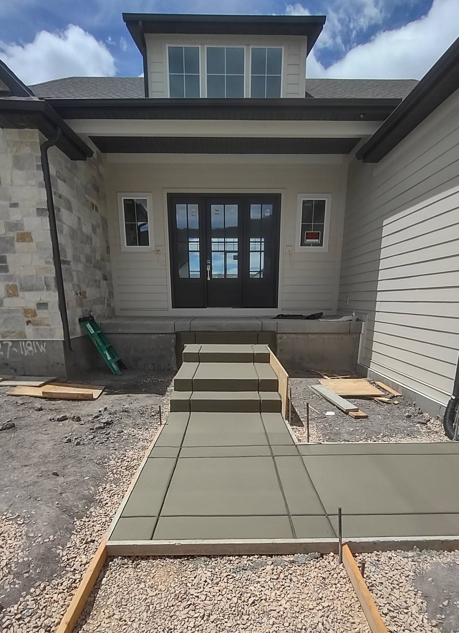 Poured concrete steps leading up to a home entry