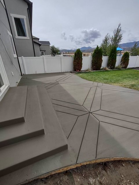 A stamped and colored decorative concrete patio in a Davis County backyard