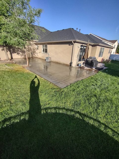 A wide finished concrete patio with clean control joints